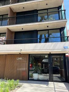 an office building with glass doors and a balcony at Link in Montevideo