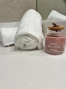 a bathroom with a towel and a jar of candle at Link in Montevideo