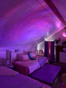 a bedroom with a purple ceiling and two beds at Alice by Ravens Keep in Jackson