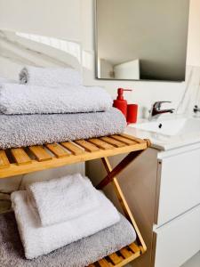 a bathroom with a stack of towels and a sink at La Mansarda di Stella in Rieti