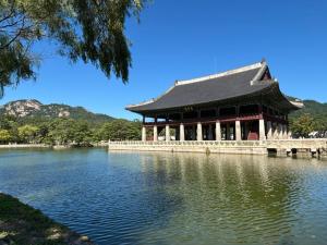a large building on the water near a lake at Hotel Myeongdong Station in Seoul