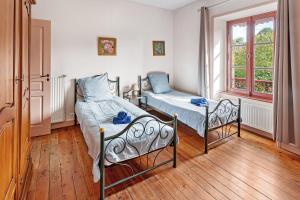 a bedroom with two beds and a window at Le Gaumier in Cugand +60 photos