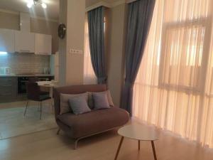 a living room with a couch and a table at Astashkina in Odesa