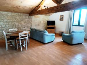 a living room with two blue couches and a table at Appartement, centre ville, 2 chambres, 6 pers in Loudun +13 photos