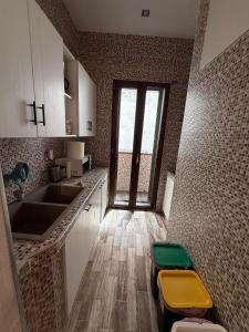 a small kitchen with a sink and a counter at La Casa del Caribe in Mola di Bari +17 photos