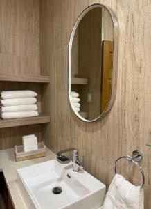 a bathroom with a white sink and a mirror at Posada de Amparo in Casas Grandes