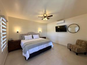 a bedroom with a bed and a ceiling fan at Posada de Amparo in Casas Grandes