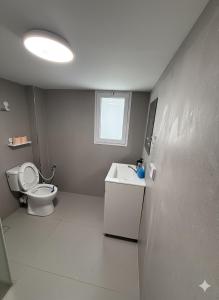 a bathroom with a toilet and a sink at Ussishkin Penthouse in Netanya +36 photos