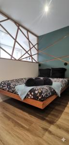 a large bed in a room with a wooden floor at Appartement Cosy avec Sauna - Angouleme - 4 personnes in Angoulême