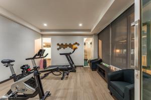a gym with two treadmills and two exercise bikes at Golden Jade Suvarnabhumi in Lat Krabang