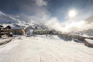 a group of people skiing down a snow covered slope at Hotel Kristall in Obertauern