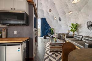 a living room with a couch and a table at Luxury Glamping Dome on Texas Farm in San Marcos