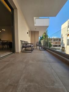 balcón con bancos y vistas a un edificio en Ethereal Residences Nafplio 1, en Nauplia