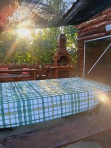 a wooden cabin with a bed and a brick oven at Sunny Side Fruska Gora- apartman A in Velika Remeta +38 photos