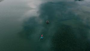 two boats in a body of water with smoke at Wenchi Eco-lodge in Dirē Kʼalu
