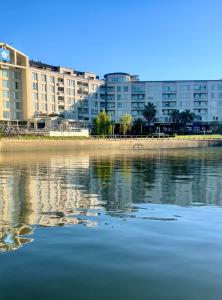 une masse d’eau avec des bâtiments en arrière-plan dans l'établissement CONDOMINIOS DE BAHIA GRANDE NORDELTA!! Tigre, à Tigre