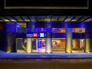 a night view of a building with blue lights at Ibis Budget Balneario Camboriu in Balneário Camboriú