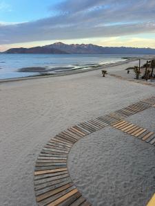 a track in the sand on a beach at Wine Hotel Punta Arena in Bahía de los Ángeles