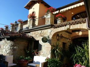 a building with a balcony with flowers on it at Il Portico in Carrosio