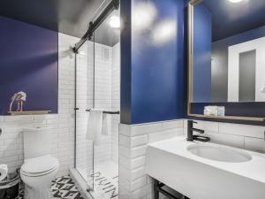 a bathroom with a toilet and a sink at Hotel Belmont Vancouver - MGallery Collection in Vancouver +47 photos