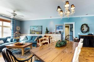 a living room with a wooden table and a couch at Aspens 4607 in Big White