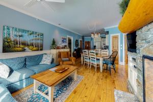 a living room with a blue couch and a table at Aspens 4607 in Big White