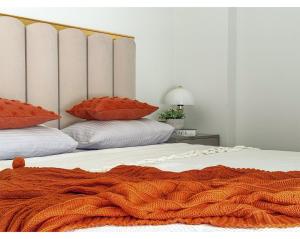 two beds with an orange blanket on top of them at Qoople Legend B - premium apartments steps from the sea in Alanya