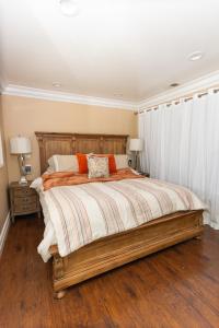 a bedroom with a large wooden bed with two lamps at Sac Camp Delta Garden Retreat in Sacramento