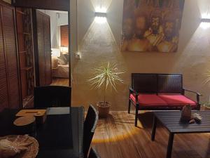 a dining room with a table and a bench at Trich Studio in La Gaulette