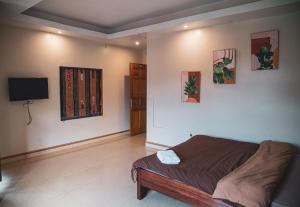 a bedroom with a bed and a flat screen tv at Sapa Central House in Sa Pa