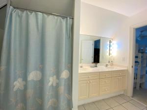 a bathroom with a shower curtain and a sink at Lookout Point in Edisto Island +31 photos