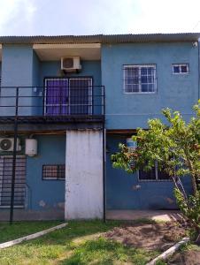 a blue building with a balcony on the side of it at Alquituc Escobar in Belén de Escobar +13 photos