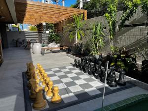 a chess board on a patio with a chess board at Studio Design 3 Apt 801 -Mandi Hospitalidade in Maceió