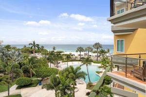 an aerial view of a resort with a swimming pool and the ocean at Beachfront - Best Beach View Studio - E422-1 in Palm-Eagle Beach