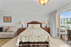 a bedroom with a bed and a couch at Beachfront - Best Beach View Studio - E422-1 in Palm-Eagle Beach +41 photos