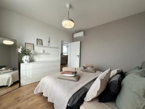 a bedroom with a large bed with two pillows on it at Labutia, self-checkin, parking, AC in Bratislava