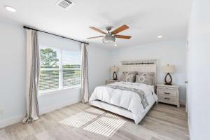 a bedroom with a bed and a ceiling fan at Blue Beak Bungalow in Pensacola +11 photos