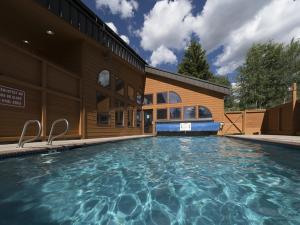 a swimming pool in front of a building at Luxury By The Lake in Dillon