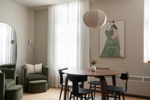 a living room with a table and chairs at Maison Saint-Vincent By Maisons & co in Montréal