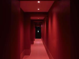 a red corridor with red walls and a red carpet at Hotel Morris Sydney, Handwritten Collection in Sydney