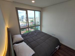 a bedroom with a bed and a large window at Luxury 2 Bedroom "Wake Up in the Sky" Best Views & Location in Asuncion in Asuncion +49 photos
