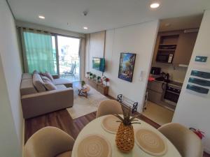 a living room with a couch and a table with a pineapple at Luxury 2 Bedroom "Wake Up in the Sky" Best Views & Location in Asuncion in Asuncion