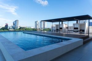 a swimming pool on the roof of a building at Luxury 2 Bedroom "Wake Up in the Sky" Best Views & Location in Asuncion in Asuncion