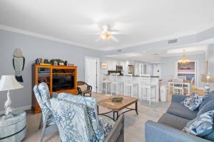 a living room with a couch and a table at Treasure Island 707 in Panama City Beach +20 photos
