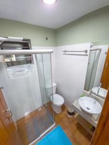 a bathroom with a shower and a toilet and a sink at Pousada Céu da Chapadha in Mucugê +56 photos