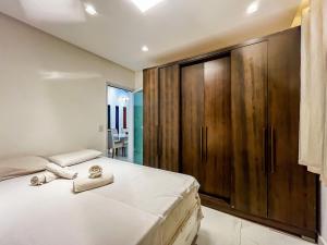 a bedroom with a large wooden cabinet next to a bed at Casa Vista Mar com piscina na Orla De Atalaia in Santa Maria +44 photos