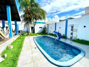a swimming pool in the backyard of a house at Casa Vista Mar com piscina na Orla De Atalaia in Santa Maria