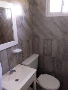 a bathroom with a toilet and a sink at Alquituc Escobar in Belén de Escobar +21 photos