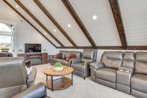 a living room with leather chairs and a table at Mtn and Lake Views Family Retreat in Garden City! in Garden City