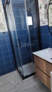 a bathroom with a glass shower and a sink at Urban relax in Dos Hermanas